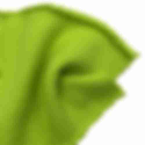 Close-up of bright lime green French Terry fabric showing the soft, textured weave of the heavyweight cotton material.
