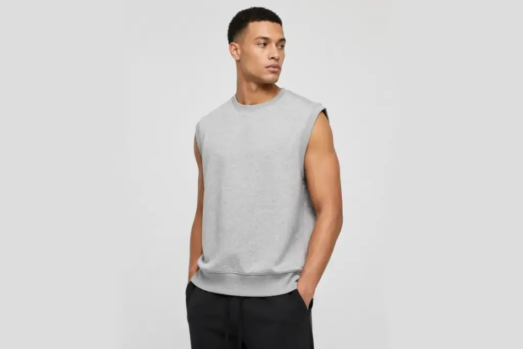 Male model wearing a gray French terry streetwear vest with a clean, structured silhouette